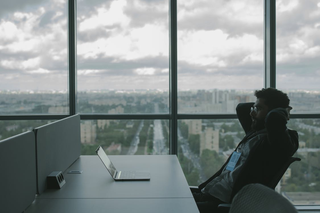 A man looking at his laptop at the workplace