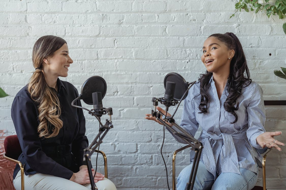 Two women recording a podcast 