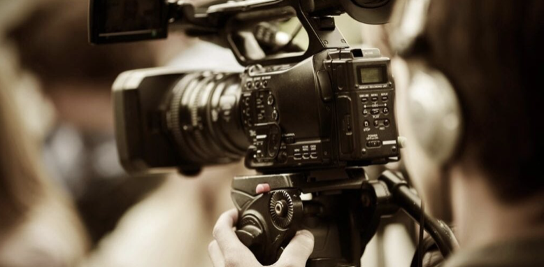  A broadcast journalist recording using a professional video camera